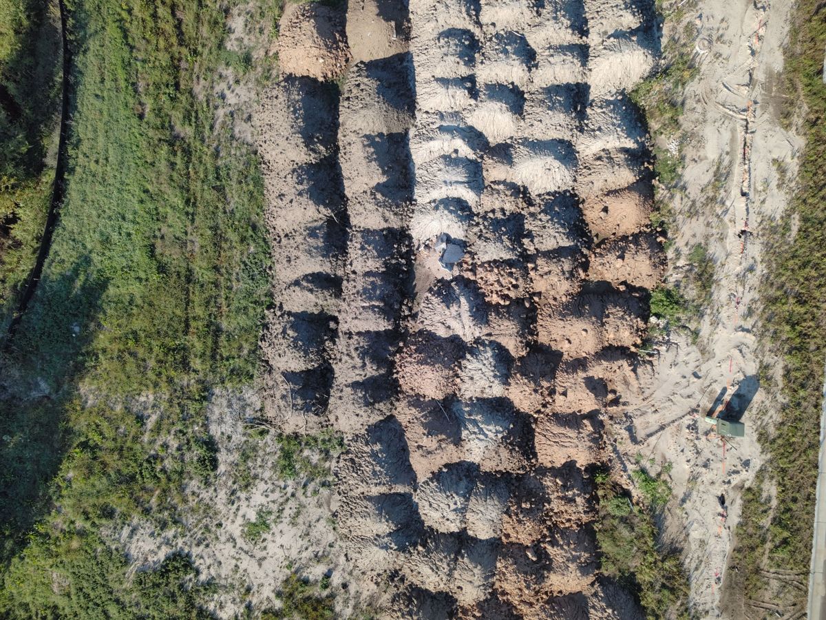 Rows of dirt stockpiles from above